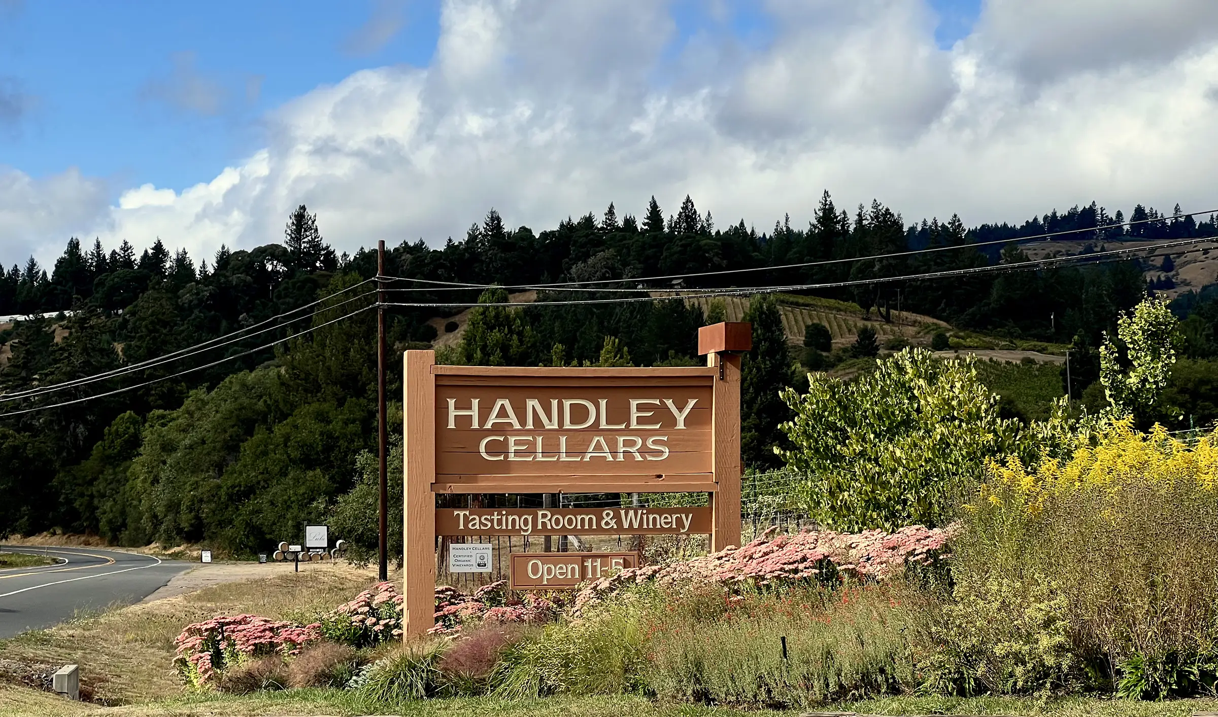 The Handley Cellars Tasting Room & Winery sign among flowers